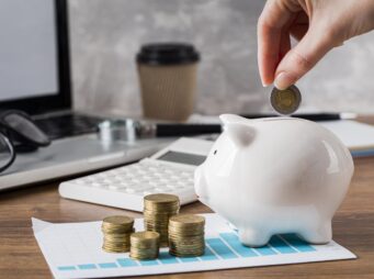 hand-putting-coin-piggy-bank-growth-chart
